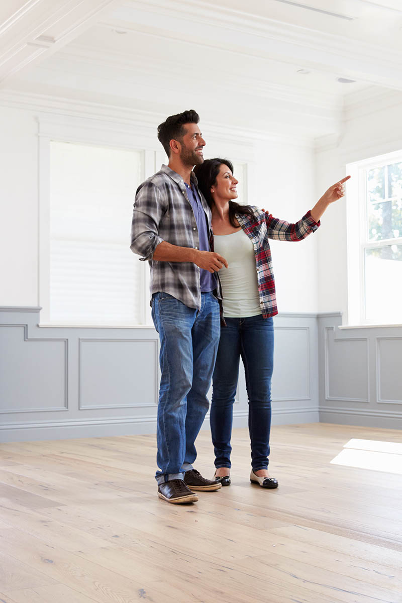 Couple standing together in their new house after a home inspection
