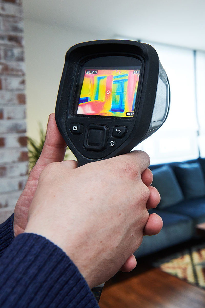 Thermal imaging device being used during a home inspection